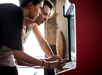 Side view of caucasian couple playing arcade game