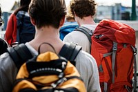 Rear view of walking backpackers group