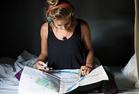 A Caucasian woman looking at a Bangkok Thailand map