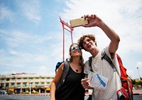 Tourists couple taking selfie with the giant swing in Bangkok Thailand