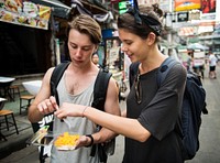 Tourist trying mango with sticky rice