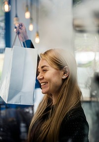 Caucasian girl smiling showing shopping bag