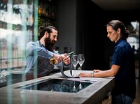 Bartender pouring a wine to the glass