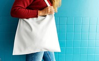 Closeup of woman with white tote bag
