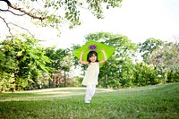 Cute little girl running with a kite in the park