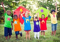 Diverse kids in colorful shirts holding kites