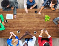 Business people using digital devices in a meeting