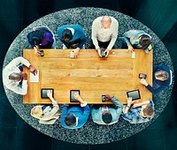 Group of Diverse People in a Table Using Devices Concept