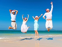 Two couple celebrating on the beach on Christmas.