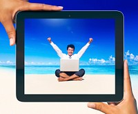 Digital Tablet with photo of a man on the beach.