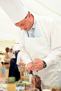 Chef is carving beef at a wedding reception.