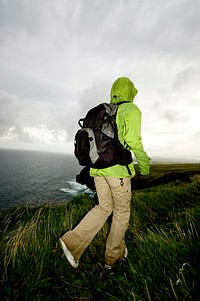 Woman is hiking at the Cliffs of Moher
