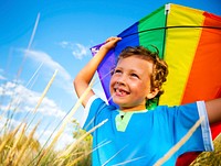 Cheerful Young Boy Playing Kite Outdoors