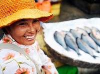 Indigenous Cambodian woman selling fish in a market.