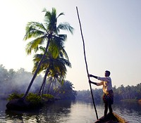 Indian boatman through the backwaters of Kerala