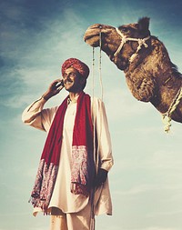 Indian man on the phone with camel
