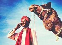Indian man on the phone with camel