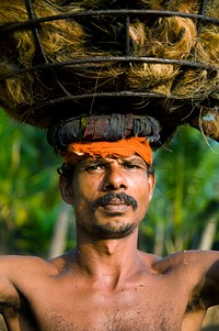 Portrait of Indian man carrying a load on his head