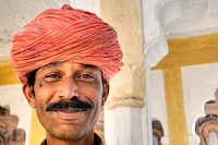 Indian man smiling to the camera.
