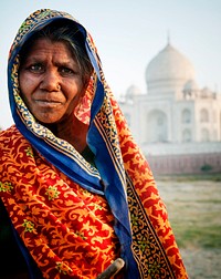 Indigenous Indian woman and The Taj Mahal as a background.