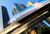 Motion blur of a skytrain speeding through a modern business district