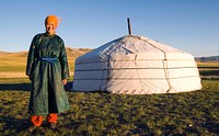 Mongolian woman standing in front of a ger