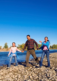 Mongolian family enjoy walking by the river.
