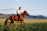 Young man riding a horse in Mongolia