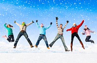 Group of friends jumping in the snow.