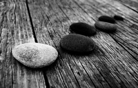 Smooth pebbles on an old wooden pier.