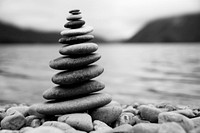 Zen balancing pebbles next to a misty lake