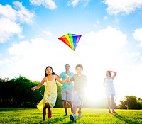 Family playing with a kite outdoors.