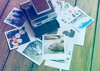 Memories of instant photos on the wooden table