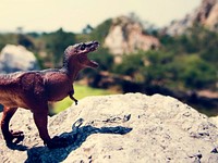 Tyrannosaurus rex jurassic figure toy on the mountain