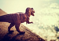Tyrannosaurus rex jurassic figure toy in the river