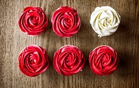 Beautiful Rose Cup Cakes on Wooden Background
