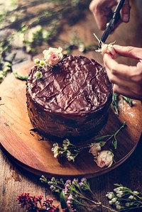 Baker Man Using Flowers Decorating Chocolate Cake