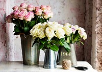 Pink and white roses in grunge tin pots