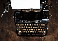 Vintage style typewriter on a wood desktop 