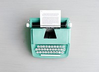 Retro pastel typewriter on grey surface
