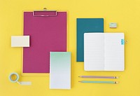 Office supplies on yellow surface 