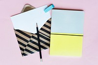 Stripe Envelope with Paper and Notebook on Pink Background