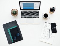 Laptop and Stationery on Working White Table