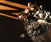 Close up of dry flowers bouquet on wooden floor