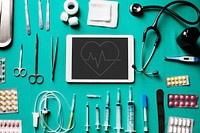 Digital tablet with medical tools on the table