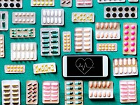 Pills and tablets with a mobile phone with a heart rate icon
