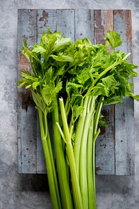 Aerial view of fresh celery on wooden background