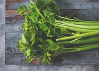 Green fresh celery on a wooden floor