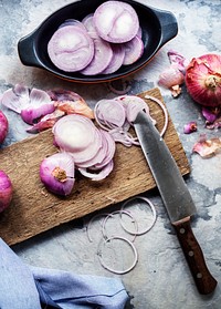 Chopped red onion on a wooden cutting board