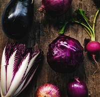 Closeup of purple vegetable group collection on wooden table